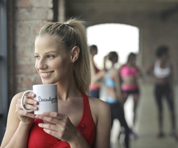 A diverse group of people smiling during a light workout session.